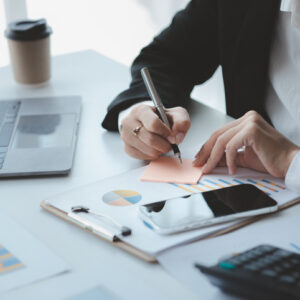 Businessman check to financial documents, he owns a startup company, he sits checking the company's financial summary prepared by the finance department. Management concept of startup company.