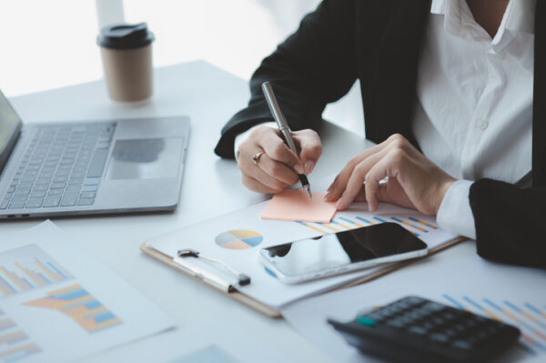 Businessman check to financial documents, he owns a startup company, he sits checking the company's financial summary prepared by the finance department. Management concept of startup company.