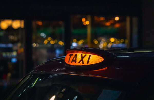 London black cab taxi sign at night