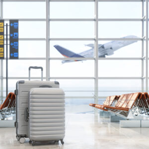 Airport Waiting Area With Luggages, Empty Seats And Blurred Background